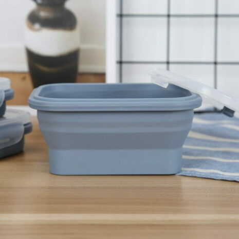 mmexport1710825388462 A Set of 4 Collapsible Food Containers (PRE ORDER LISTING – DISPATCH DATE 1st MAY) on a wooden kitchen counter, with their transparent lids partially open and additional containers in the background.